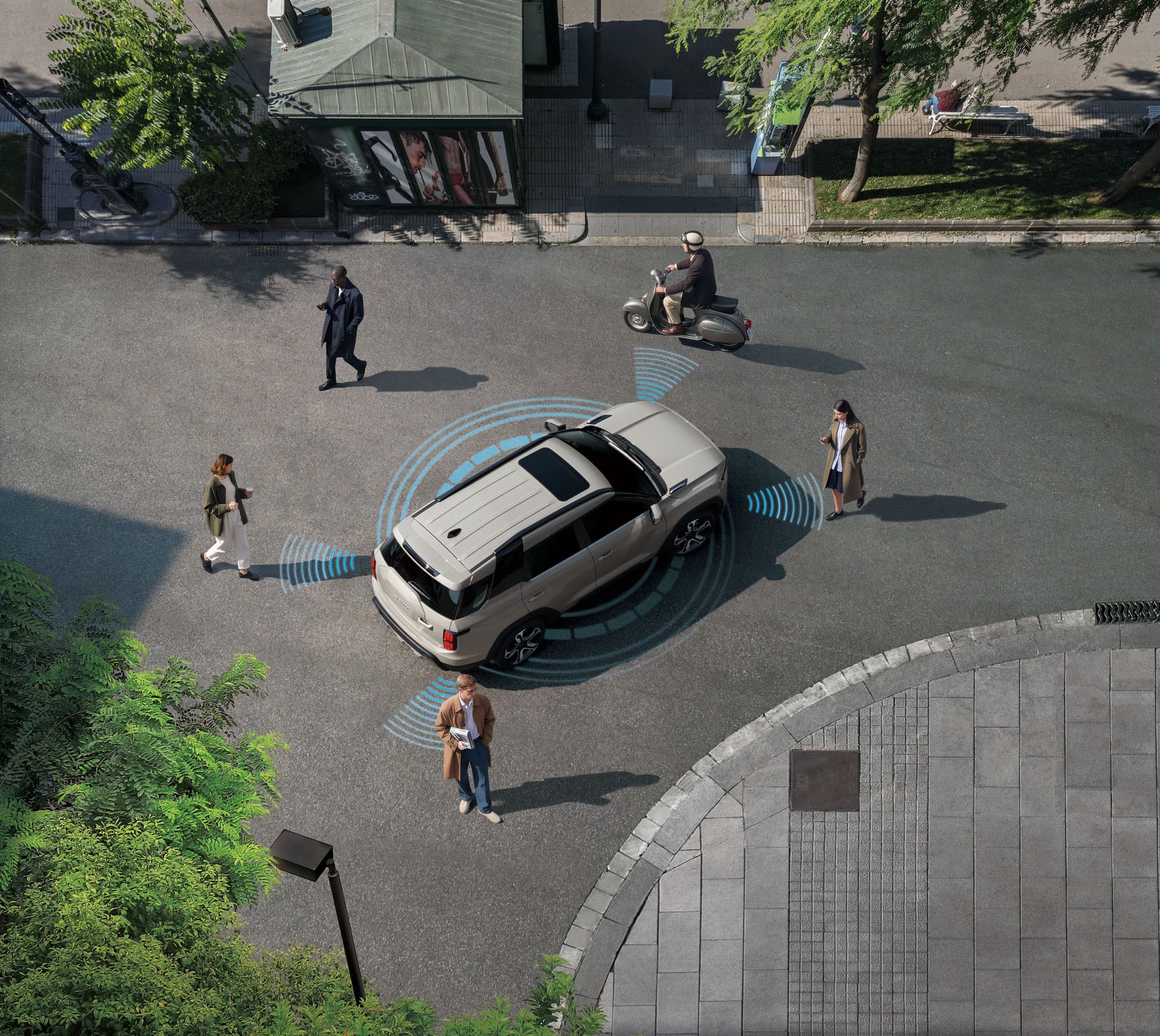 Aerial view of a KGM Torres EVX using sensors to detect four pedestrians and a scooter on a city street, with trees and a kiosk nearby.